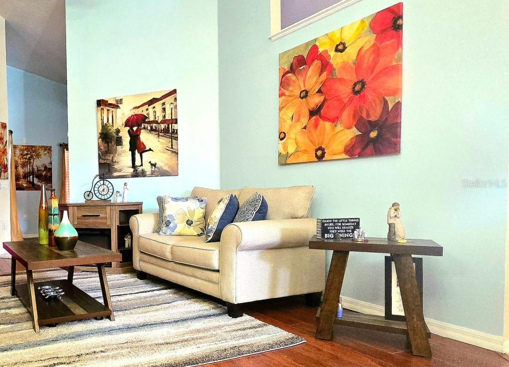 13541 Tetherline Trail Orlando, FL 32837 - Photo 8 of 39 a living room with furniture and wall paintings