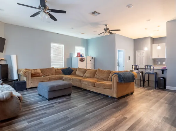 a living room with furniture and a chandelier