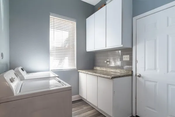 a kitchen with a sink cabinets and window