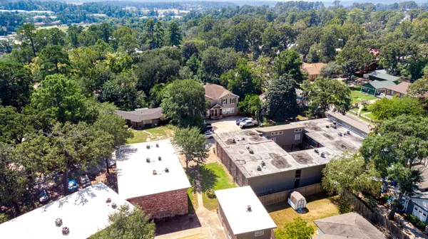 an aerial view of a house with yard and mountain view in back
