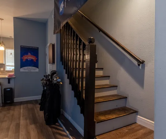 a view of entryway and hall with wooden floor