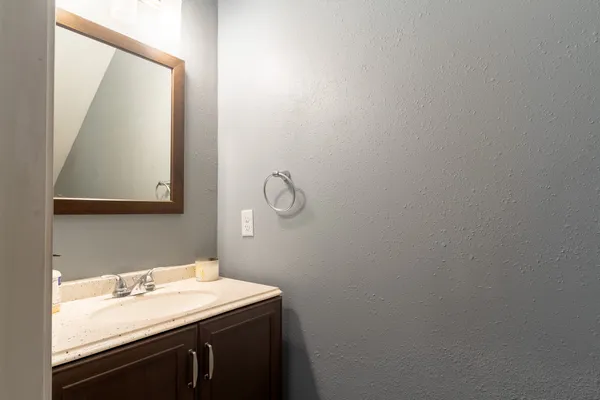 a bathroom with a granite countertop sink and a mirror