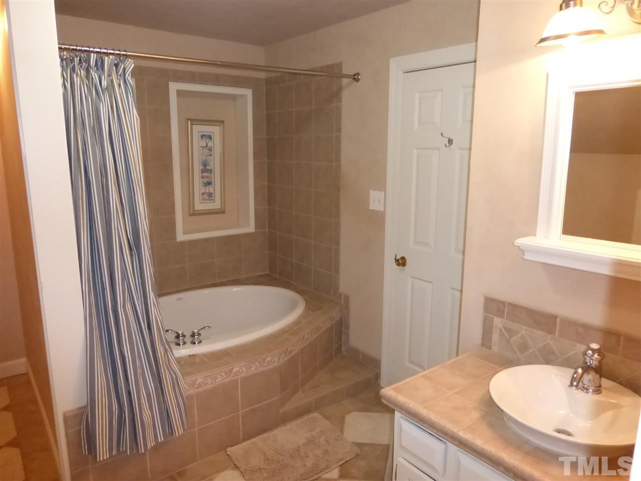 6846 Gloucester Road Raleigh, NC 27612 - Photo 13 of 18 a bathroom with a sink and a mirror