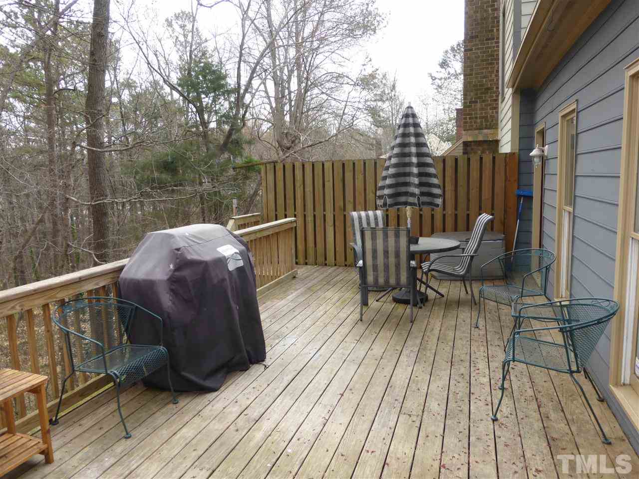 6846 Gloucester Road Raleigh, NC 27612 - Photo 16 of 18 a view of balcony with wooden floor and outdoor seating