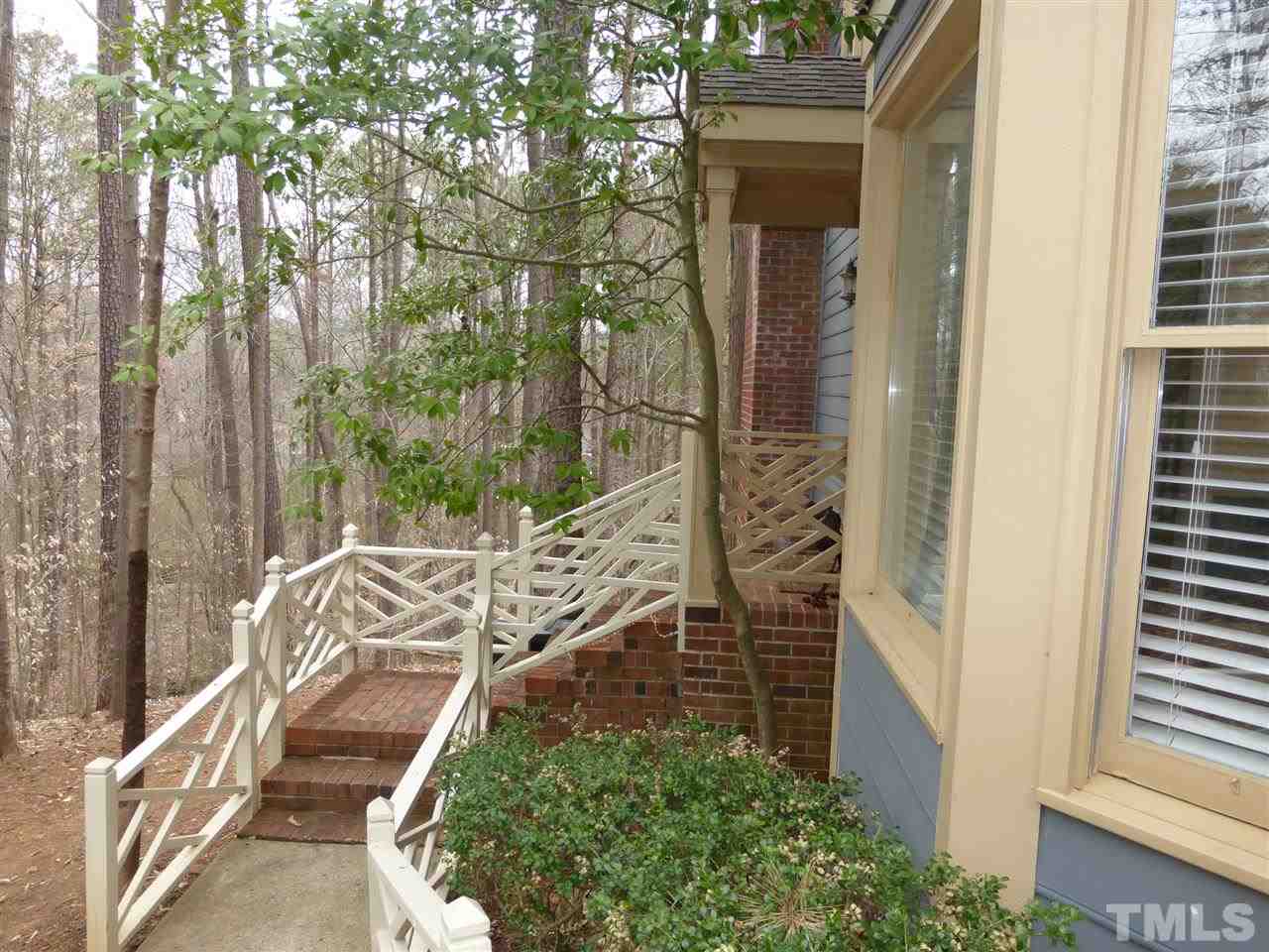 6846 Gloucester Road Raleigh, NC 27612 - Photo 3 of 18 a view of a wooden door with a tree