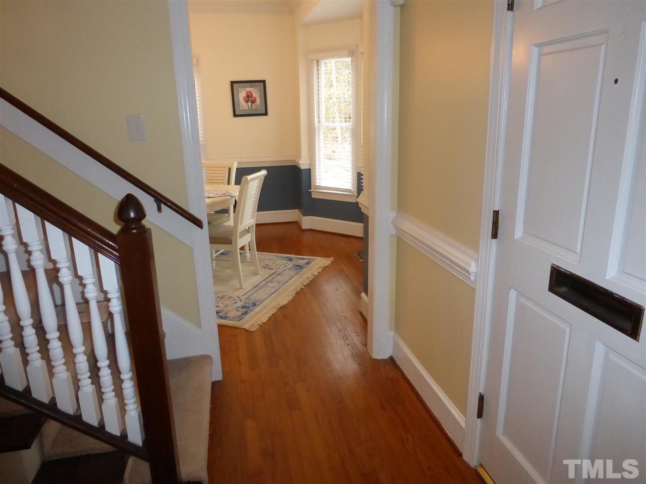 6846 Gloucester Road Raleigh, NC 27612 - Photo 4 of 18 a view of a hallway with wooden floor and stairs