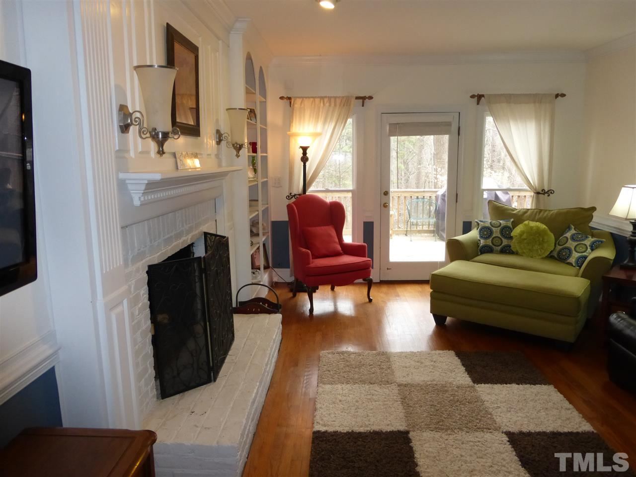 6846 Gloucester Road Raleigh, NC 27612 - Photo 7 of 18 a living room with furniture and a fireplace