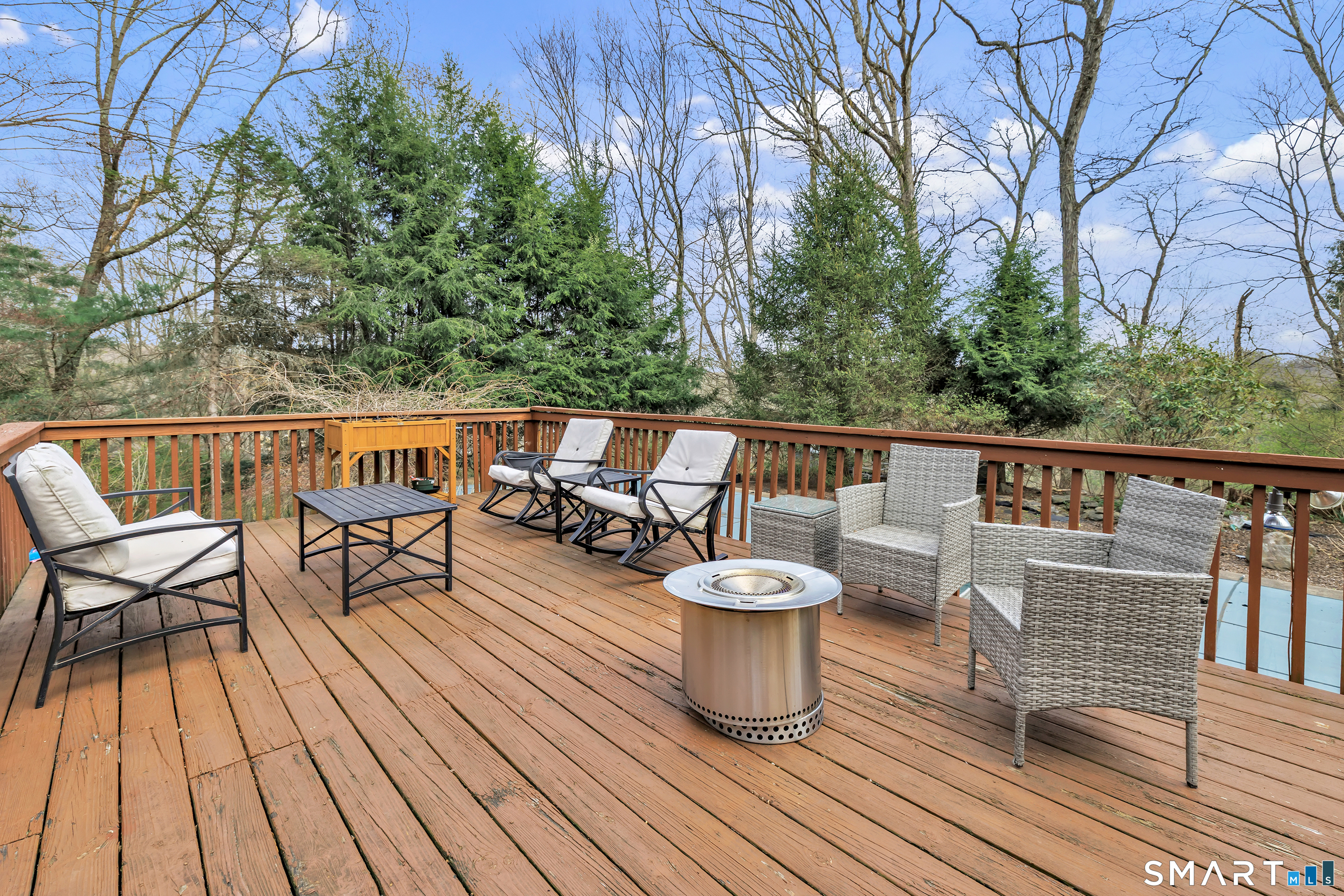 16 Mountain Road Wilton, CT 06897 - Photo 30 of 40 a view of a roof deck with table and chairs and wooden floor