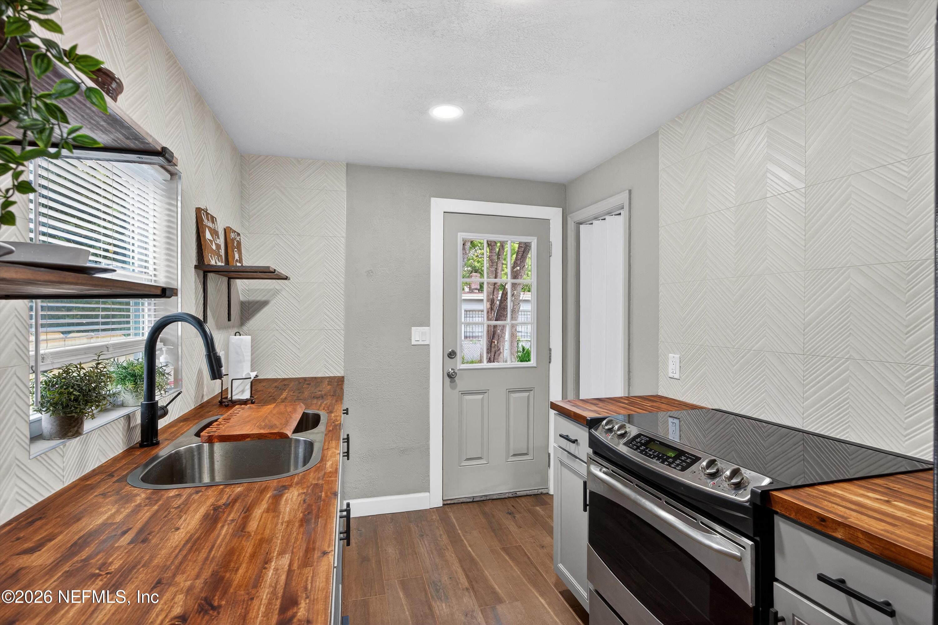 1741 Tyler Street Jacksonville, FL 32209 - Photo 11 of 25 a kitchen with a refrigerator and a sink