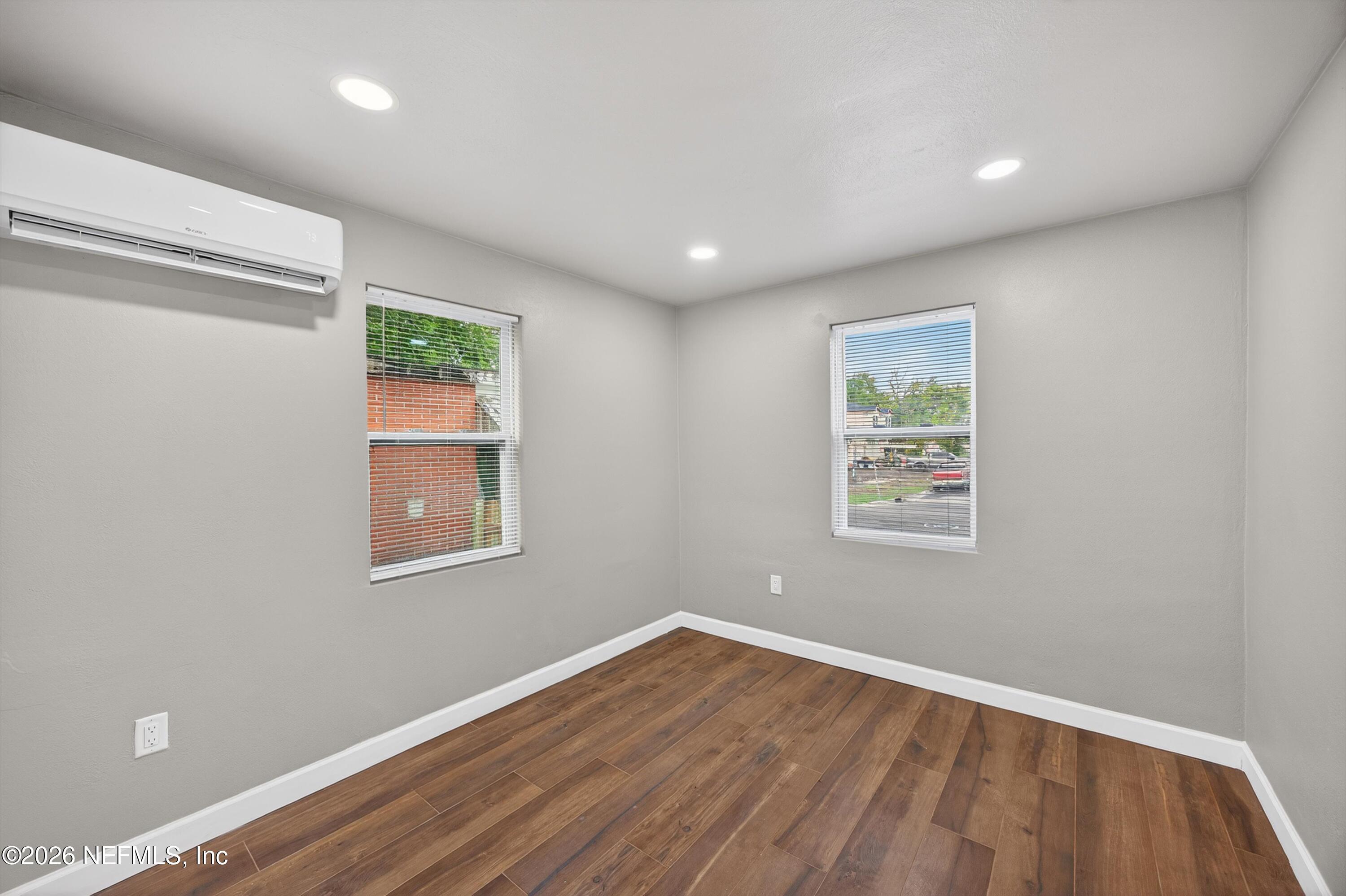 1741 Tyler Street Jacksonville, FL 32209 - Photo 14 of 25 an empty room with wooden floor and a window