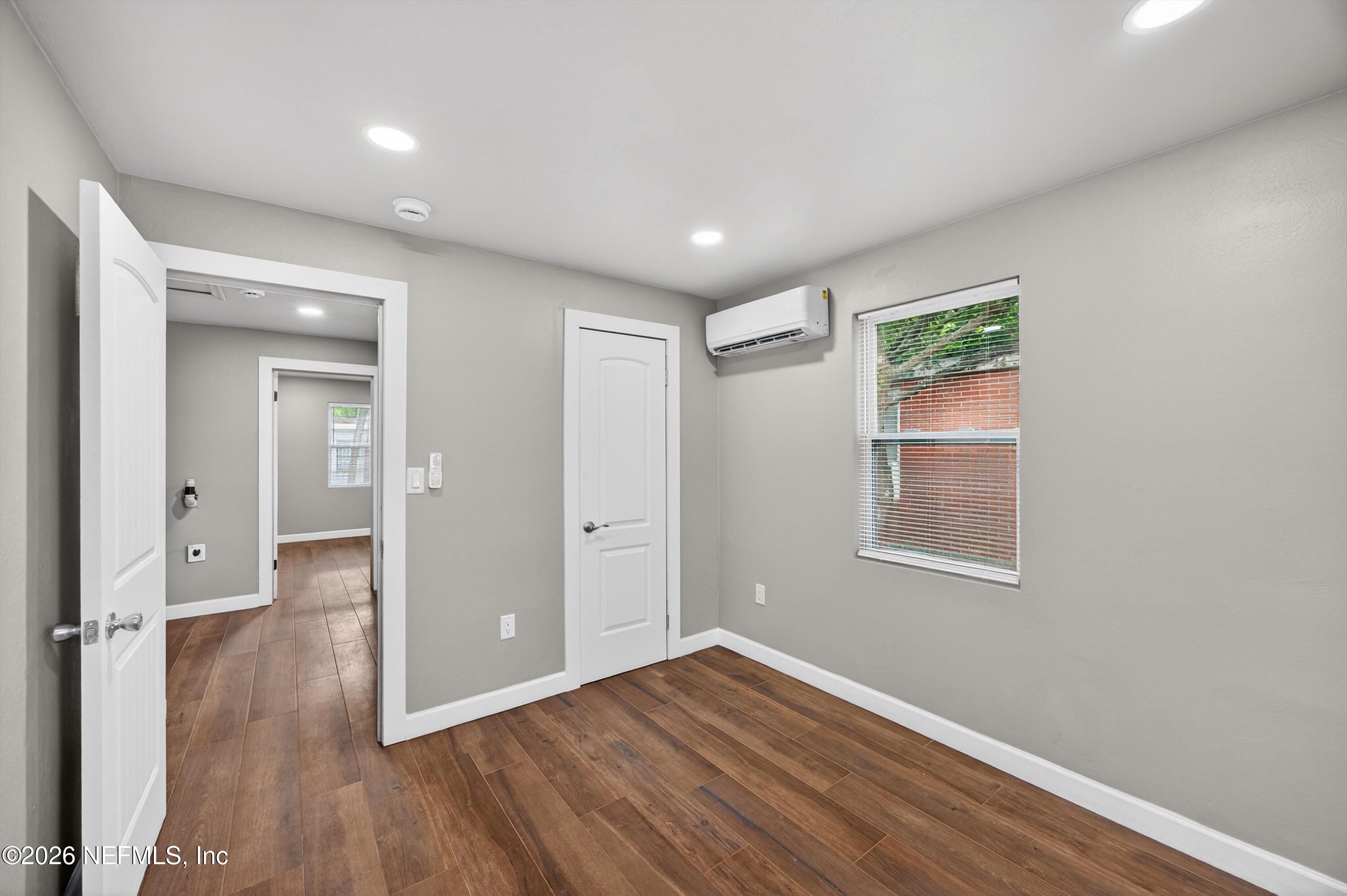 1741 Tyler Street Jacksonville, FL 32209 - Photo 15 of 25 wooden floor in an empty room with a window