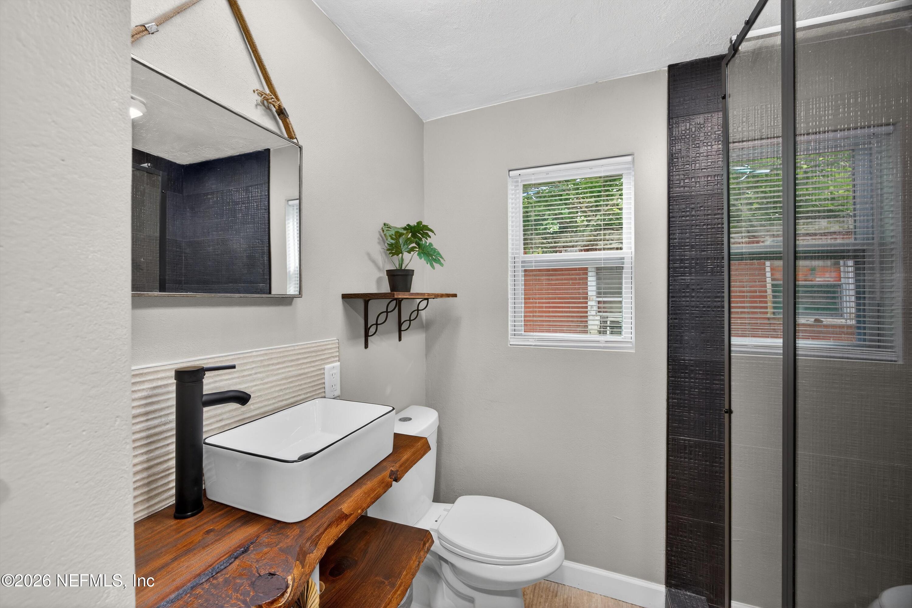 1741 Tyler Street Jacksonville, FL 32209 - Photo 17 of 25 a white toilet sitting next to a bathroom sink