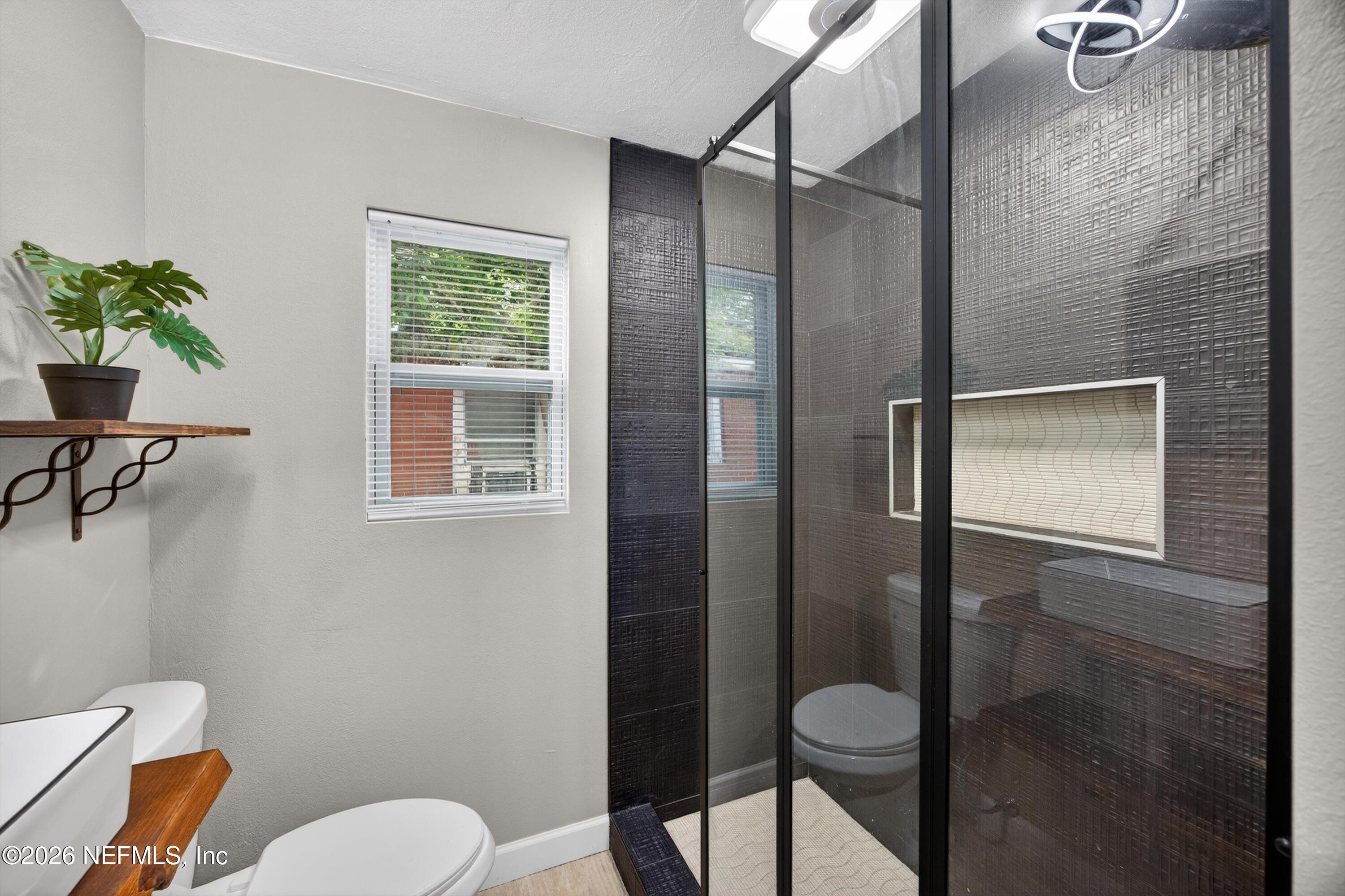 1741 Tyler Street Jacksonville, FL 32209 - Photo 18 of 25 a bathroom with a toilet and a shower