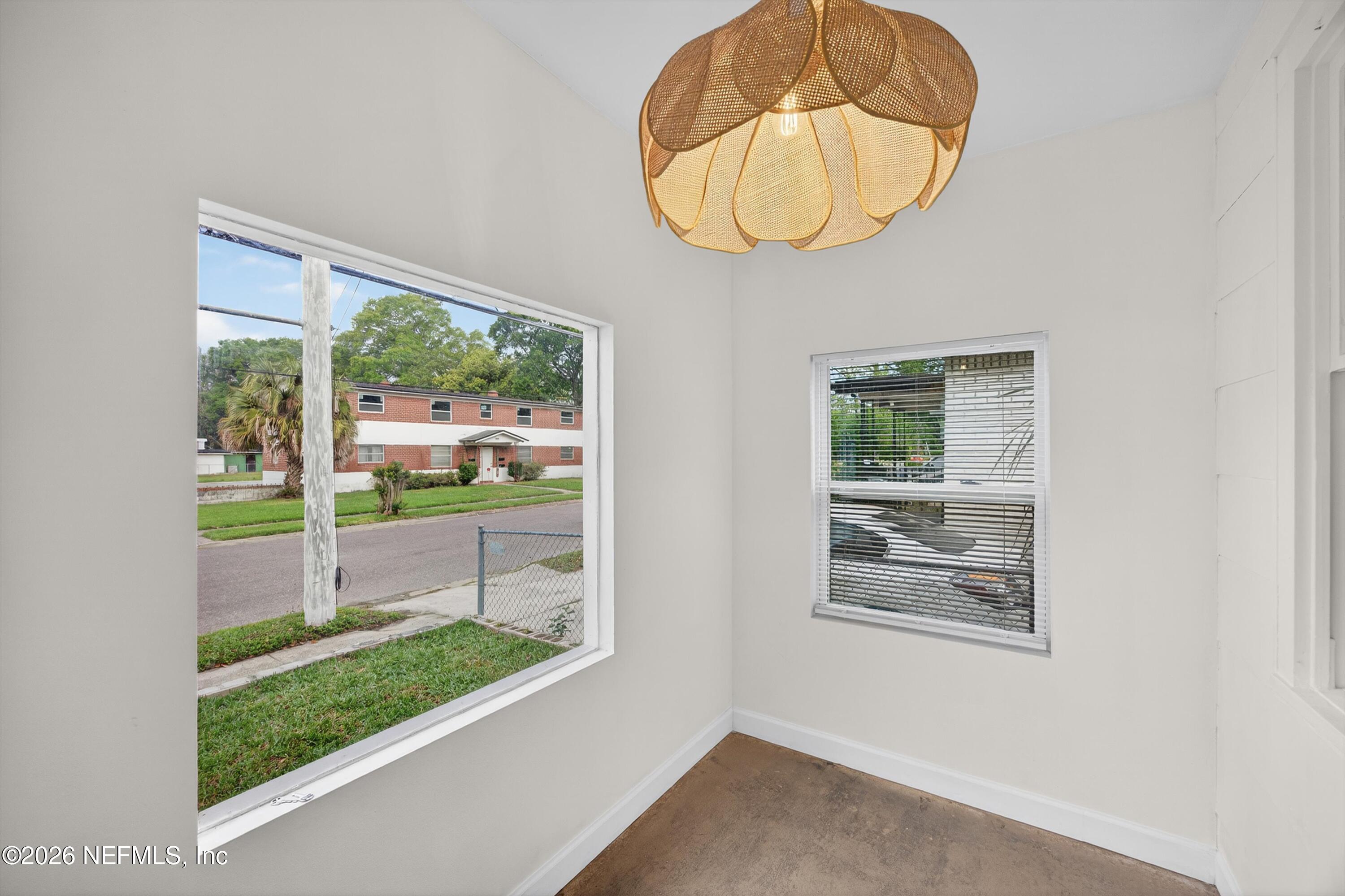 1741 Tyler Street Jacksonville, FL 32209 - Photo 3 of 25 a room with wooden floor and a painting on the wall