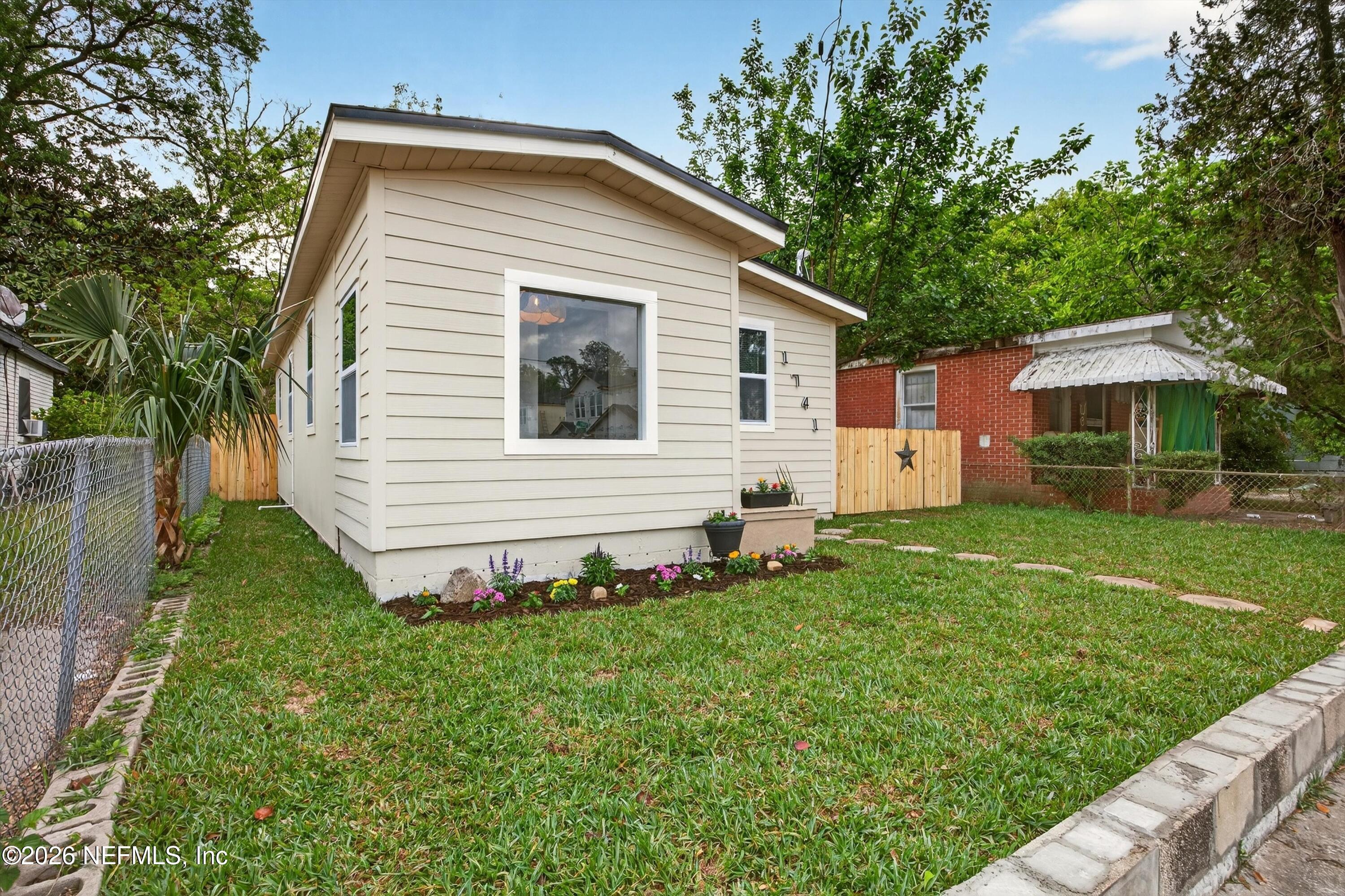 1741 Tyler Street Jacksonville, FL 32209 - Photo 5 of 25 a front view of a house with a yard