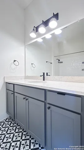 a bathroom with a sink and a mirror