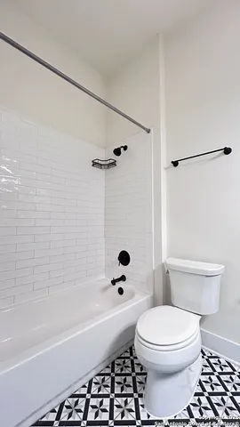 a bathroom with a toilet a sink and a bathtub