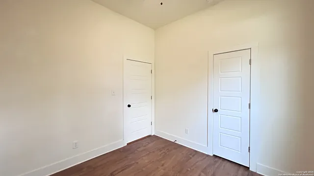 an empty room with wooden floor