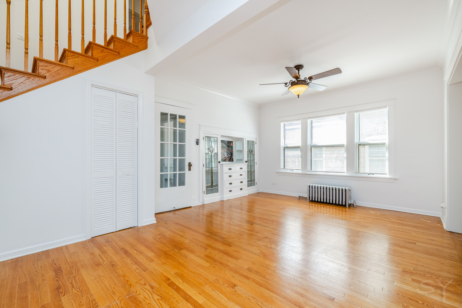 6752 Riverside Drive Berwyn, IL 60402 - Photo 5 of 33 a view of an empty room with a window and wooden floor