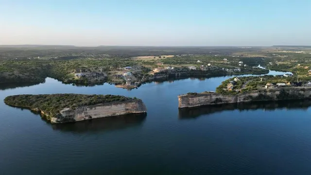 an aerial view of a houses with a lake view