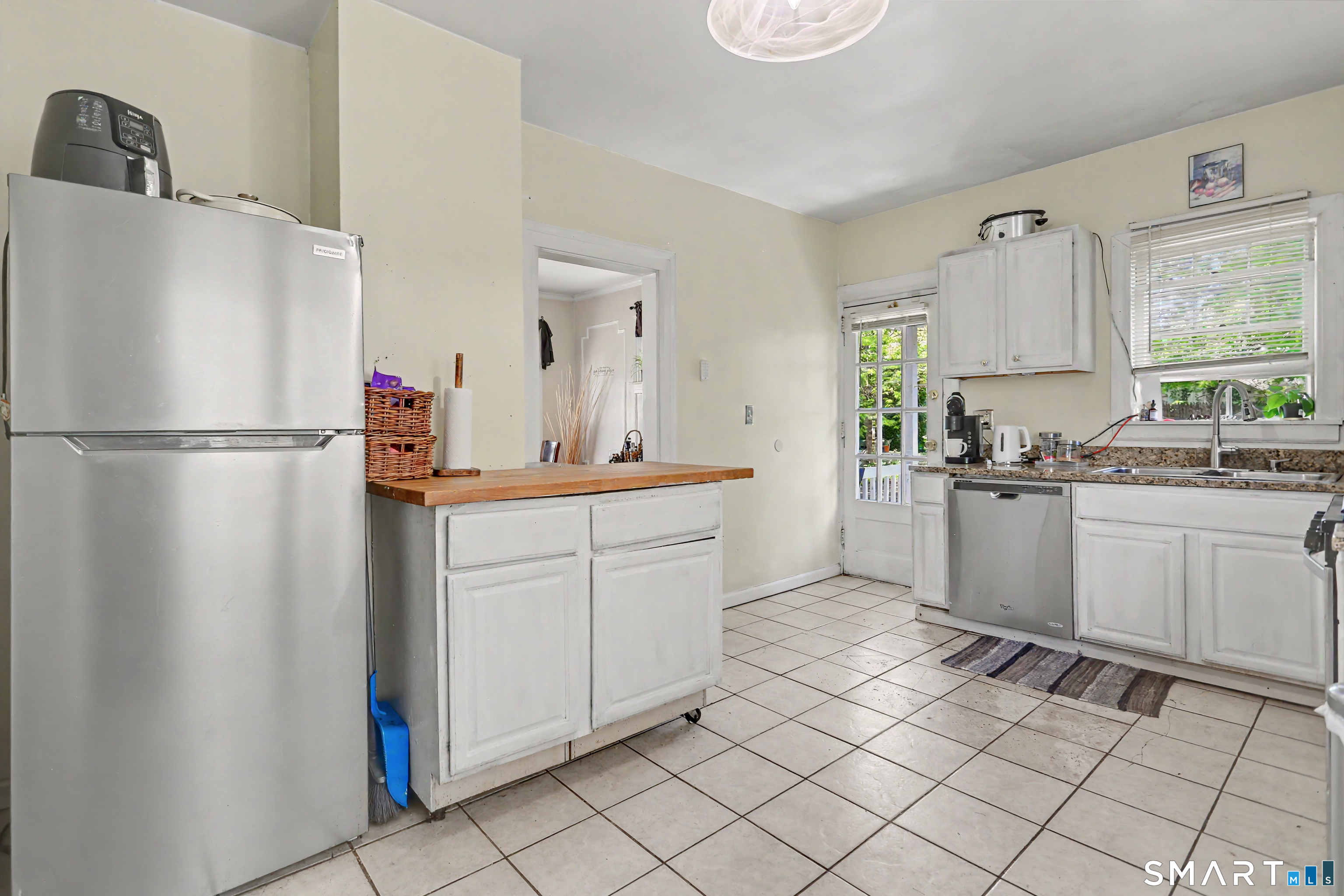 94 2nd Street Hamden, CT 06514 - Photo 15 of 31 a kitchen with a refrigerator sink and cabinets