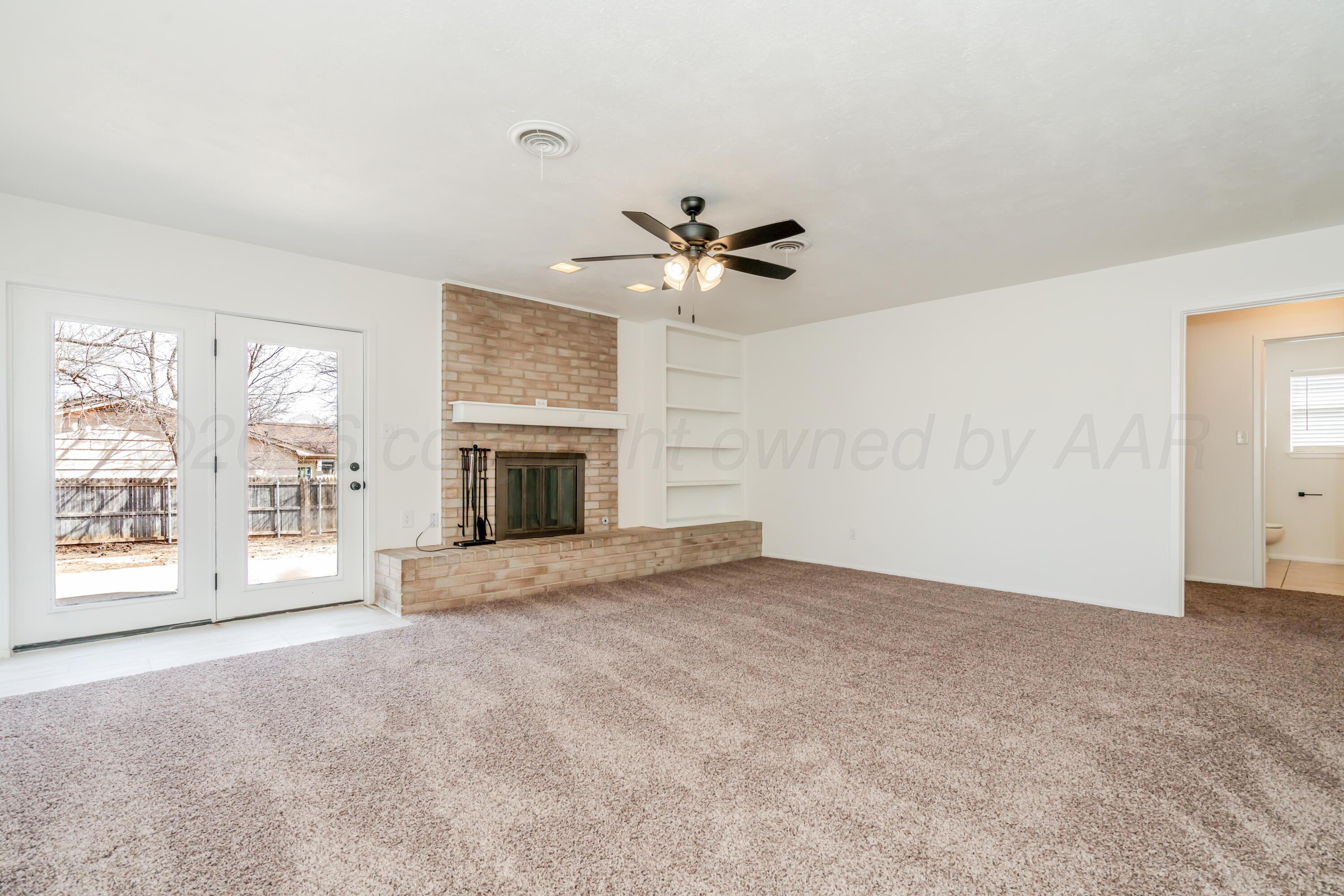1001 5th Street Canyon, TX 79015 - Photo 12 of 34 an empty room with windows and fireplace