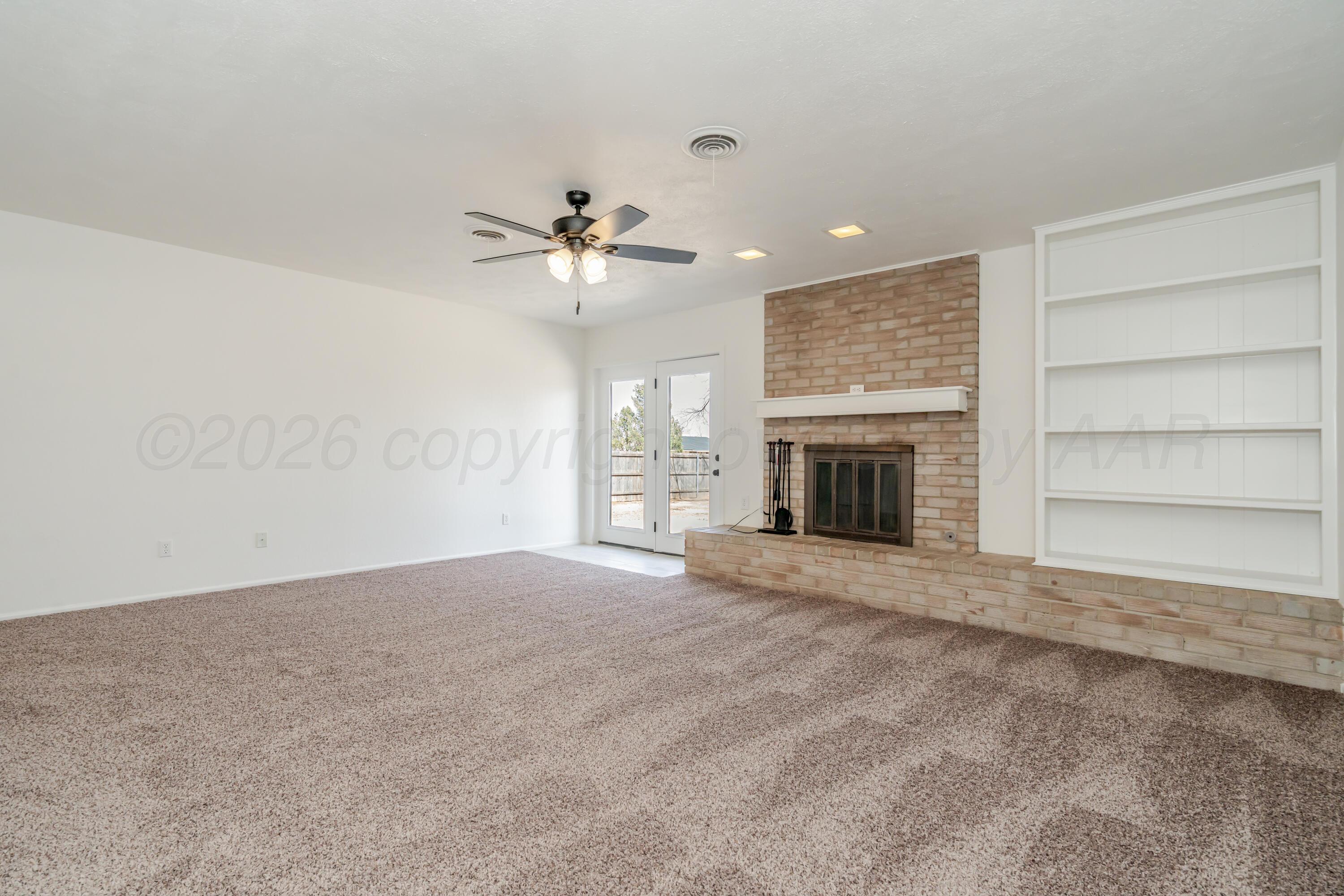 1001 5th Street Canyon, TX 79015 - Photo 13 of 34 a view of an empty room with a fireplace and a window