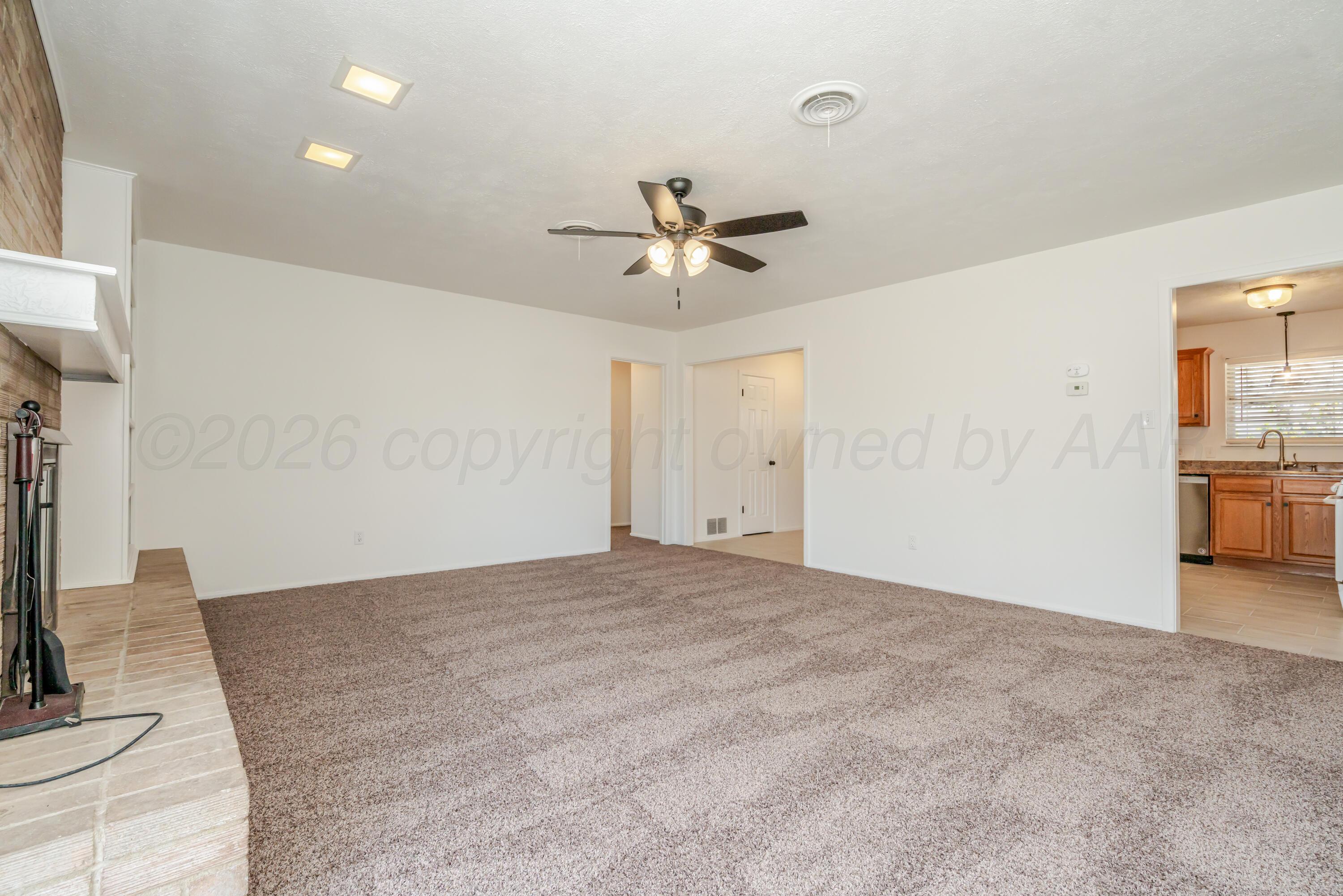 1001 5th Street Canyon, TX 79015 - Photo 14 of 34 a view of a livingroom with a fireplace a sink and a chandelier