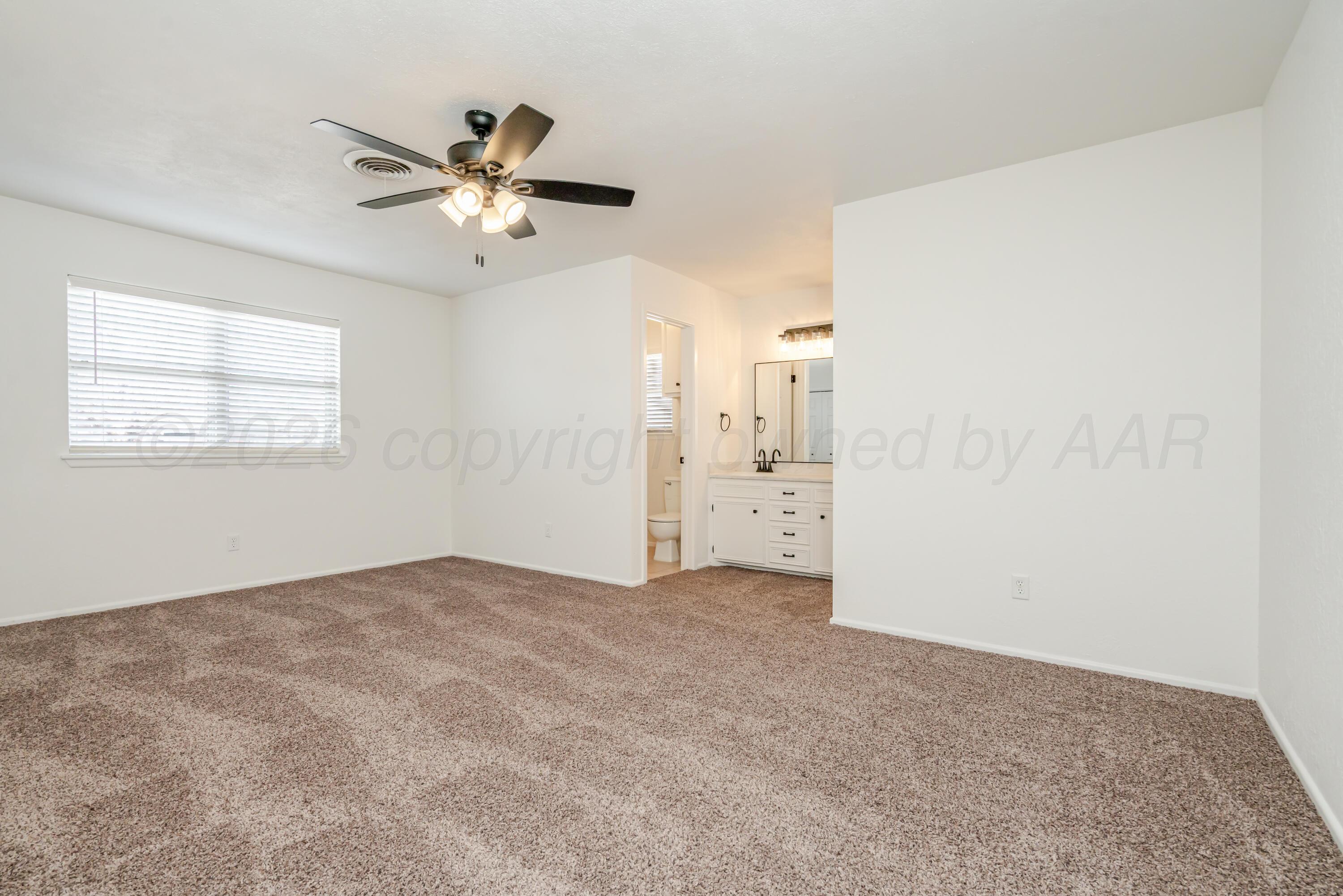 1001 5th Street Canyon, TX 79015 - Photo 15 of 34 an empty room with windows and fan