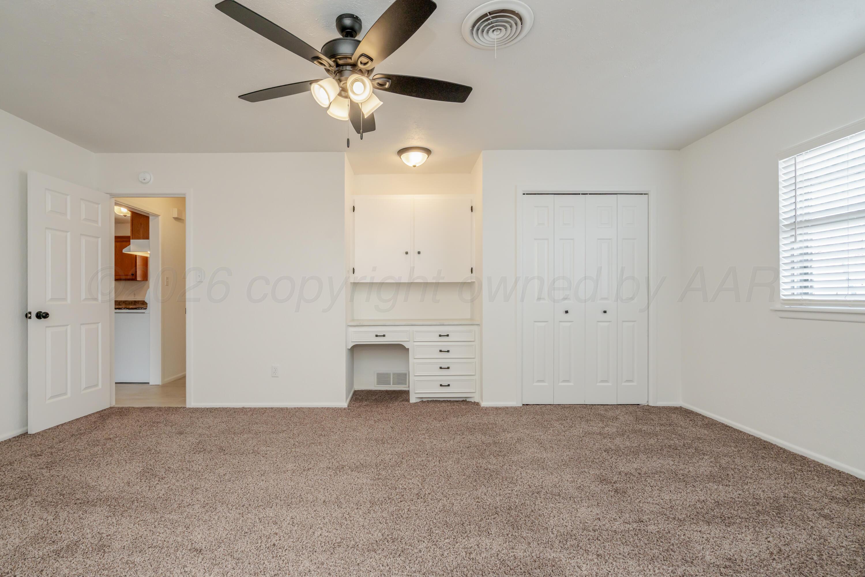 1001 5th Street Canyon, TX 79015 - Photo 16 of 34 an empty room with a ceiling fan and a window