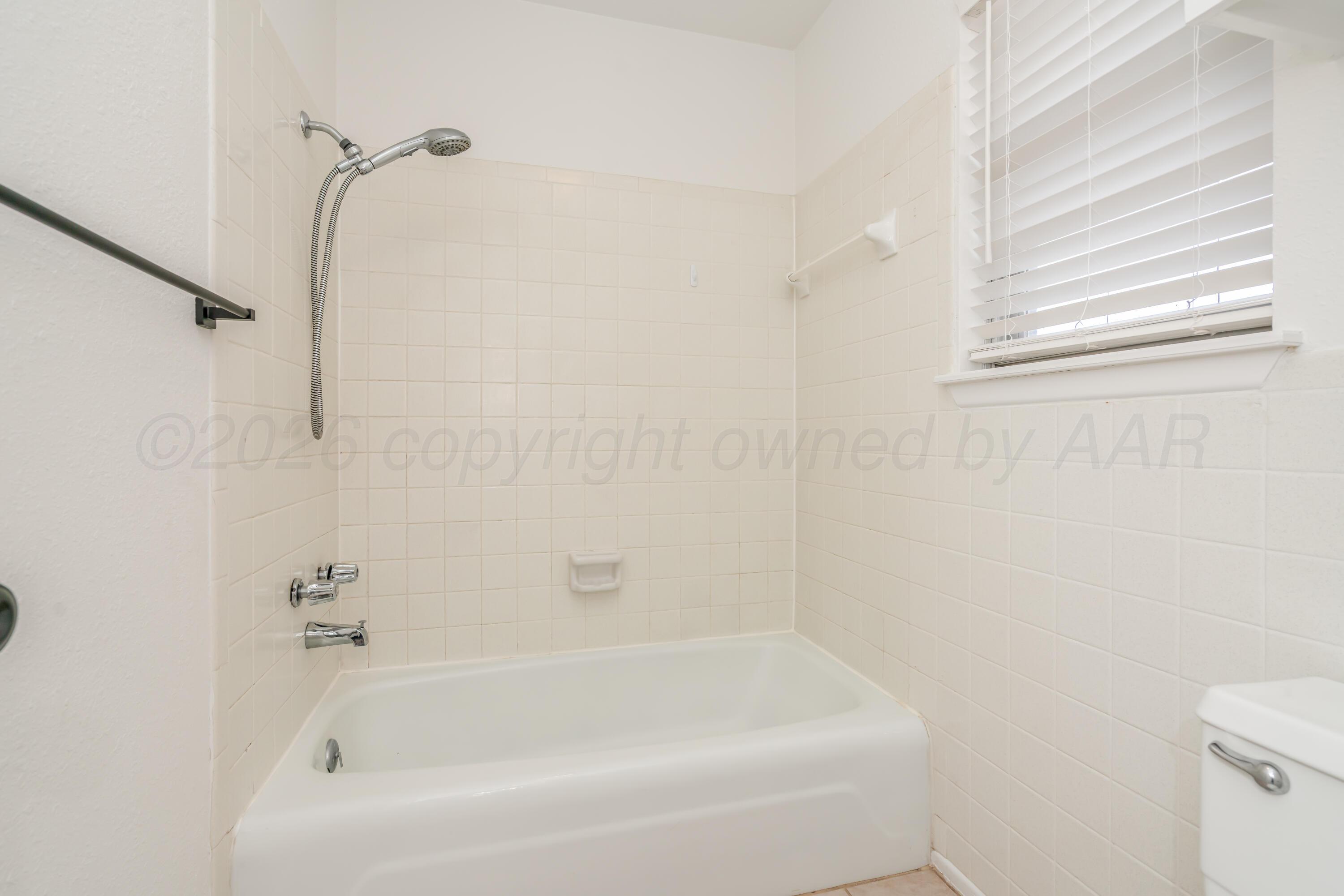 1001 5th Street Canyon, TX 79015 - Photo 21 of 34 a bathroom with a bathtub