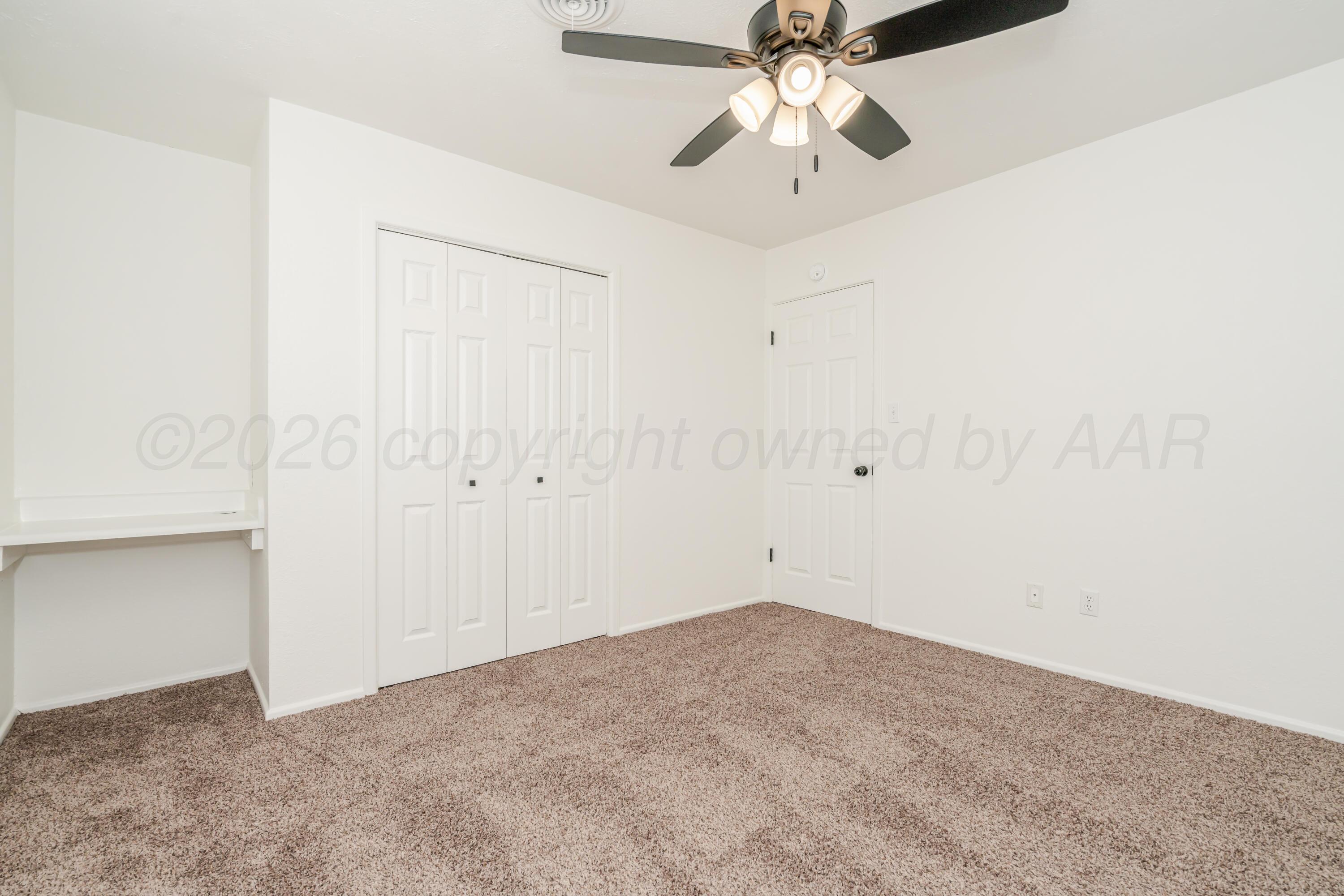 1001 5th Street Canyon, TX 79015 - Photo 25 of 34 an empty room with a chandelier fan and closet