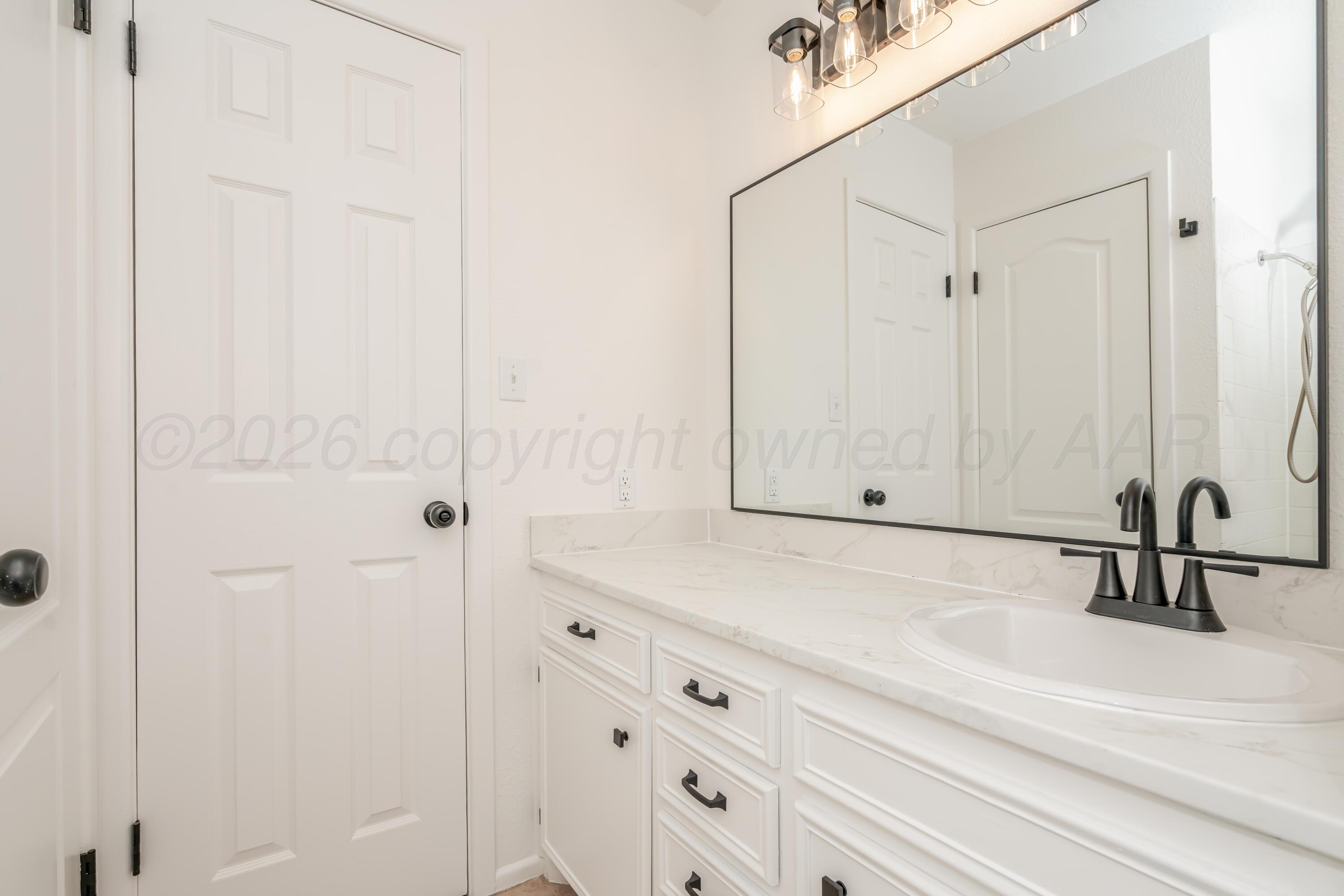 1001 5th Street Canyon, TX 79015 - Photo 27 of 34 a bathroom with a sink and a mirror