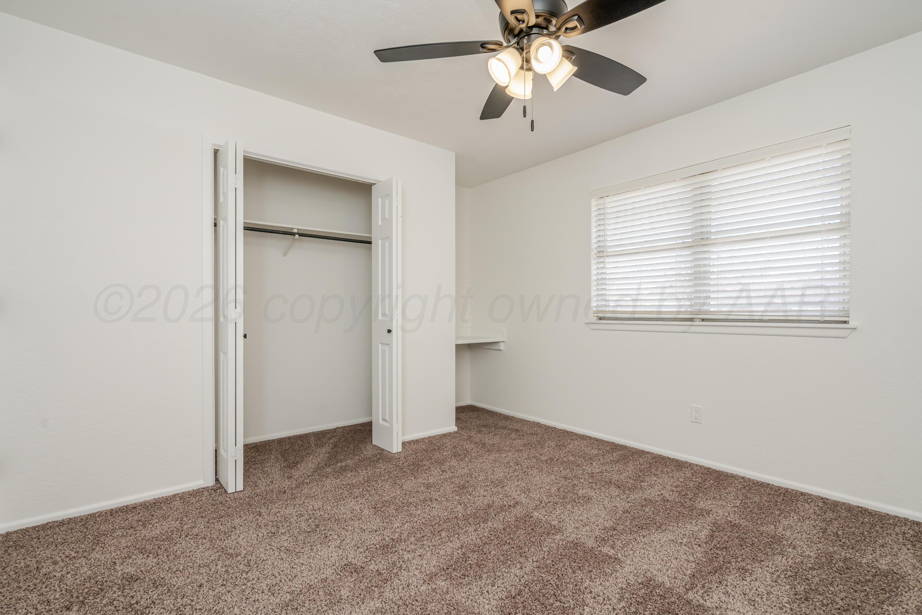 1001 5th Street Canyon, TX 79015 - Photo 29 of 34 an empty room with a window and a ceiling fan