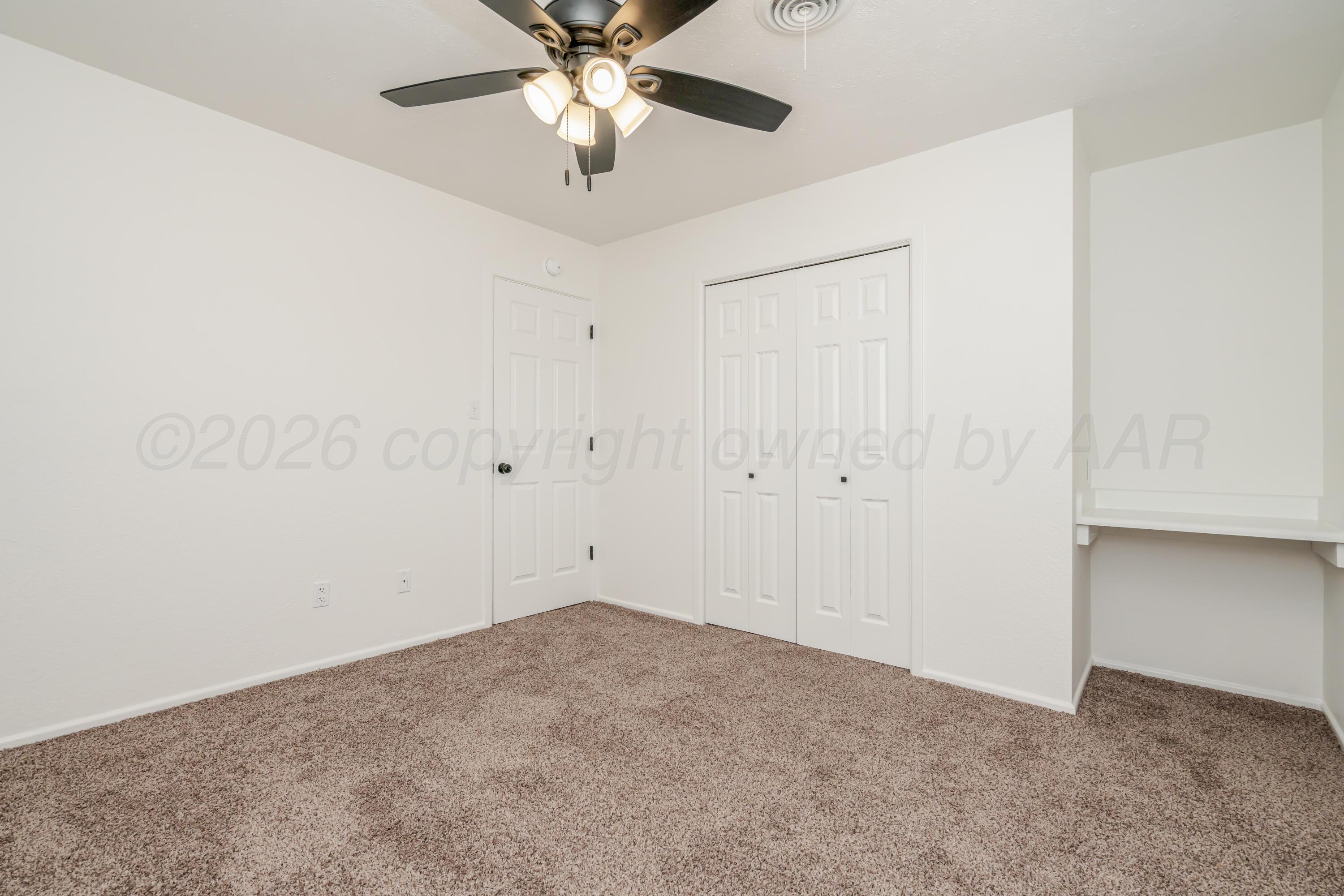 1001 5th Street Canyon, TX 79015 - Photo 31 of 34 an empty room with a ceiling fan and a window