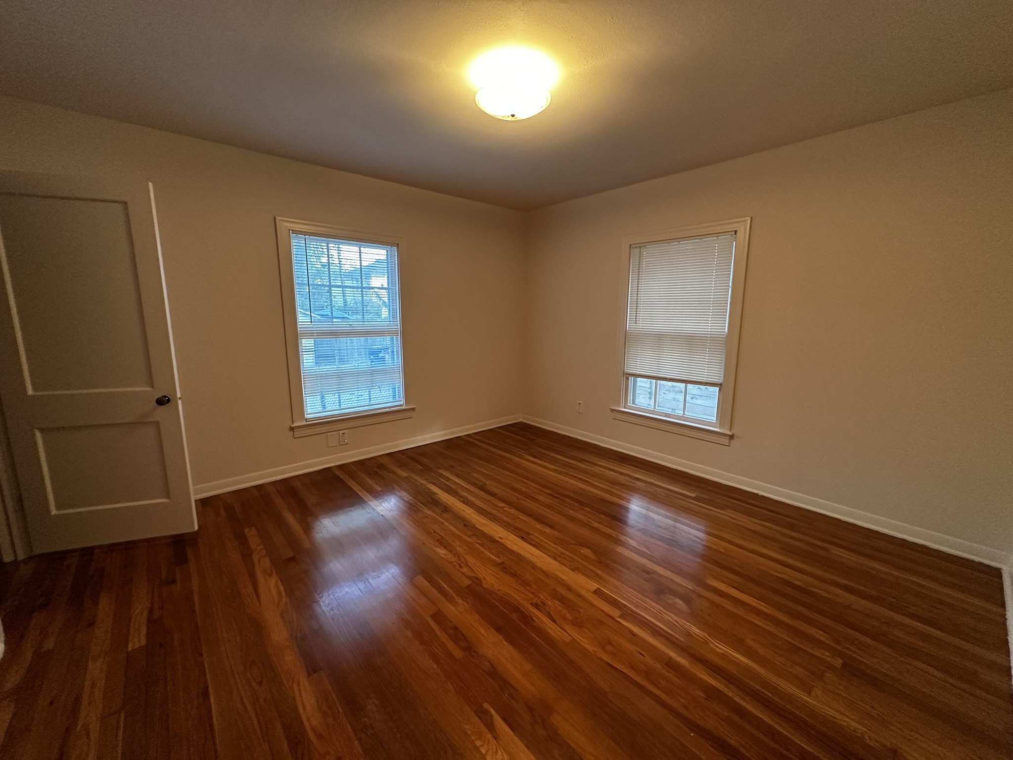 3903 Ridgelea Drive Austin, TX 78731 - Photo 12 of 17 Polished hardwood floors and dual windows establish a classic tone in this bedroom.