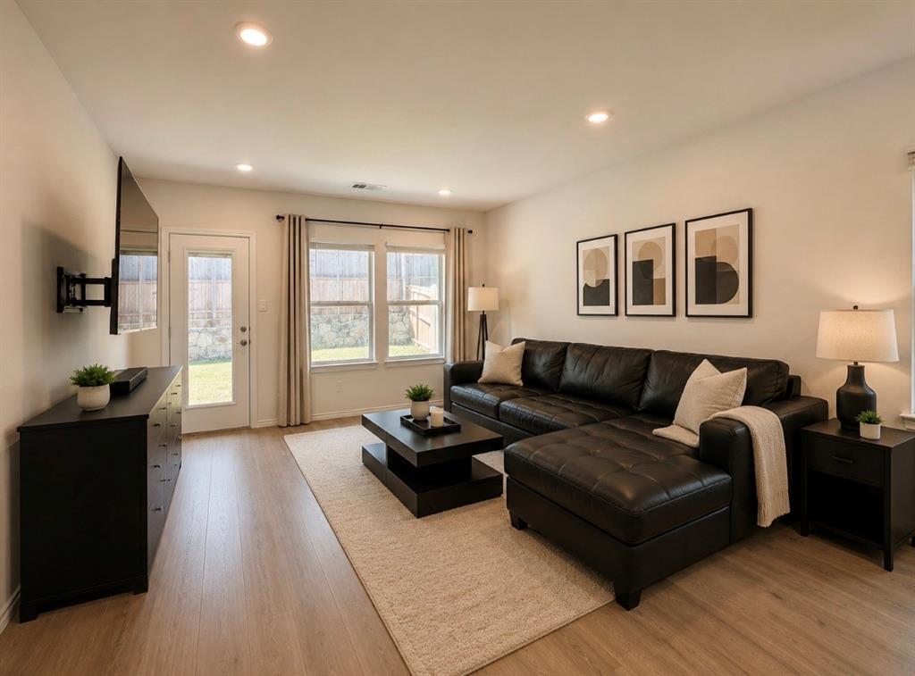 816 Country Road Royse City, TX 75189 - Photo 4 of 24 Open-concept living space featuring wood-finish flooring, recessed lighting, and a neutral wall palette