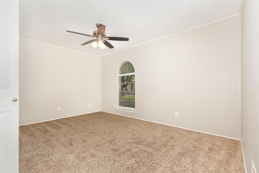 1108 Overdowns Drive Plano, TX 75023 - Photo 11 of 20 an empty room with a window and a fan