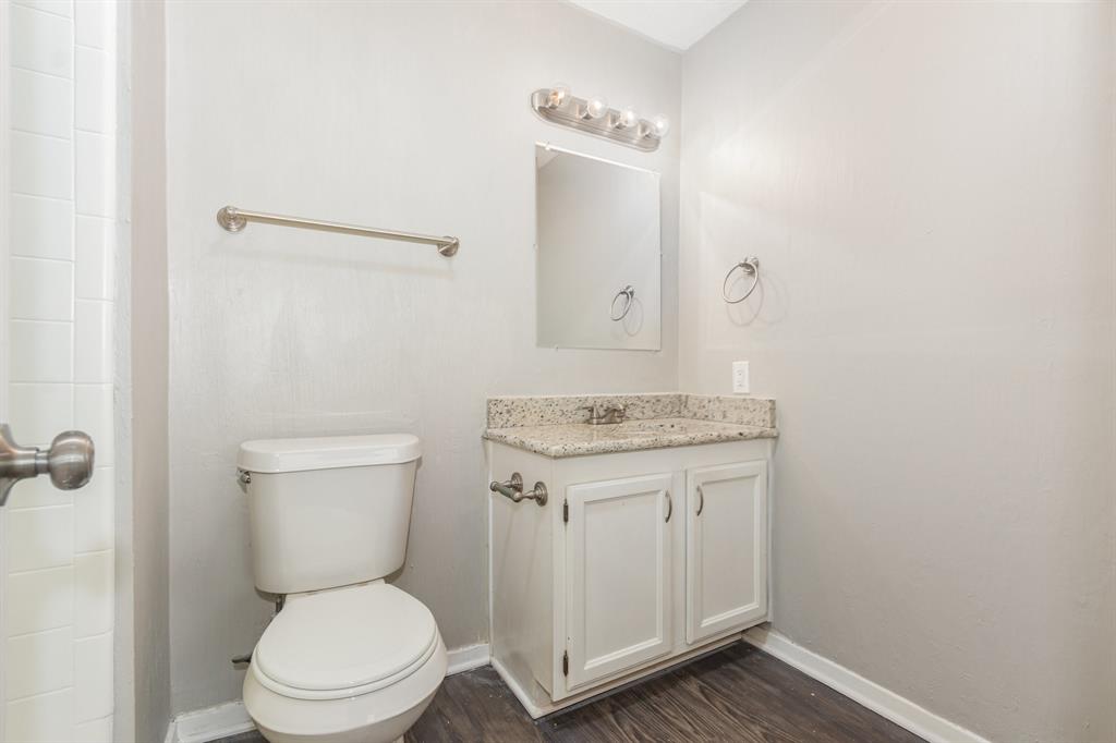 1108 Overdowns Drive Plano, TX 75023 - Photo 14 of 20 a bathroom with a granite countertop toilet a sink and a mirror