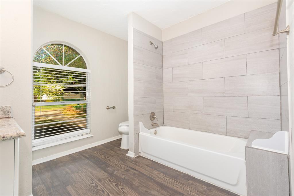 1108 Overdowns Drive Plano, TX 75023 - Photo 18 of 20 a bathroom with a sink a bathtub and a shower