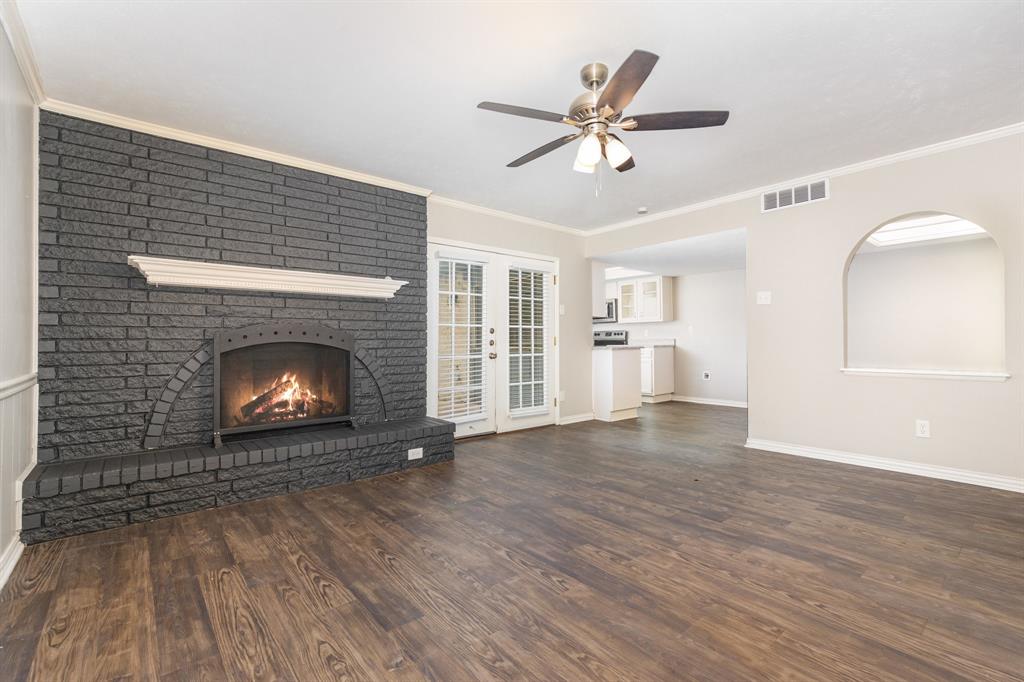 1108 Overdowns Drive Plano, TX 75023 - Photo 3 of 20 a view of an empty room with wooden floor fireplace and a window