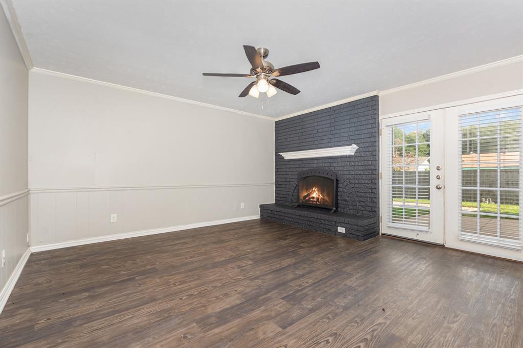 1108 Overdowns Drive Plano, TX 75023 - Photo 4 of 20 a view of empty room with wooden floor and fireplace