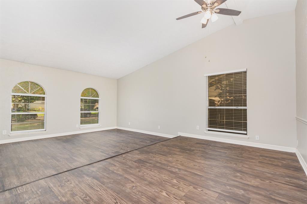 1108 Overdowns Drive Plano, TX 75023 - Photo 7 of 20 a view of an empty room with a window and wooden floor