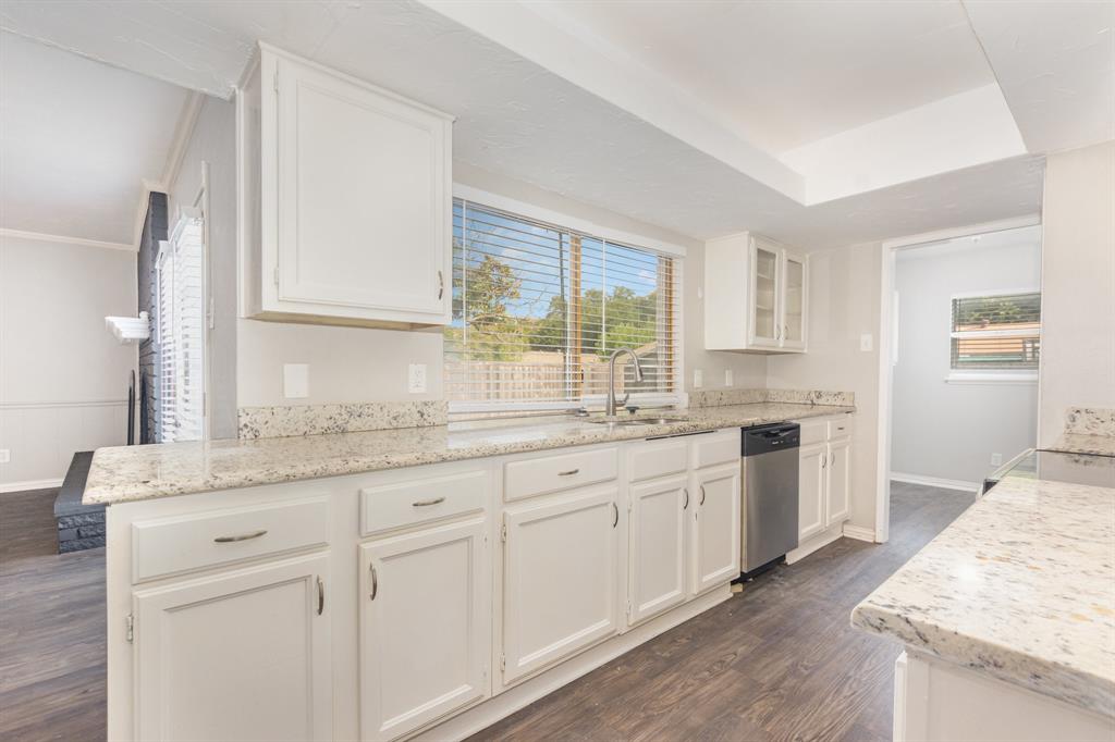 1108 Overdowns Drive Plano, TX 75023 - Photo 8 of 20 a kitchen with granite countertop white cabinets and white appliances