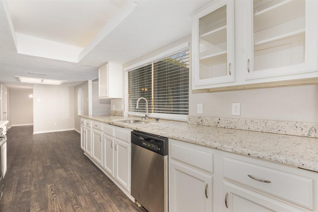1108 Overdowns Drive Plano, TX 75023 - Photo 10 of 20 a kitchen with granite countertop a sink and a white cabinets