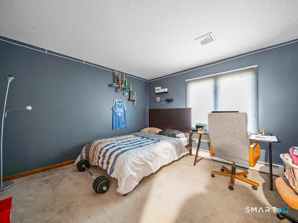 a bedroom with a bed and a chair