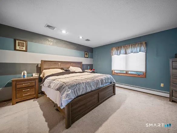 a bedroom with a bed and with furniture