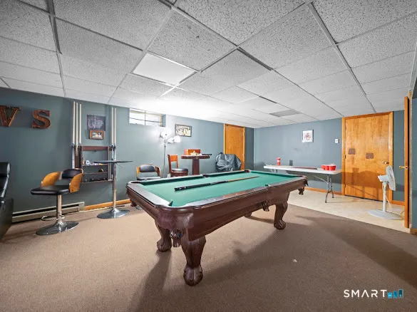 a room with furniture and pool table