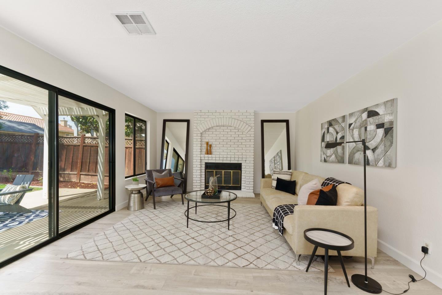 6702 Paseo Catalina Pleasanton, CA 94566 - Photo 13 of 44 a living room with furniture a fireplace and a floor to ceiling window