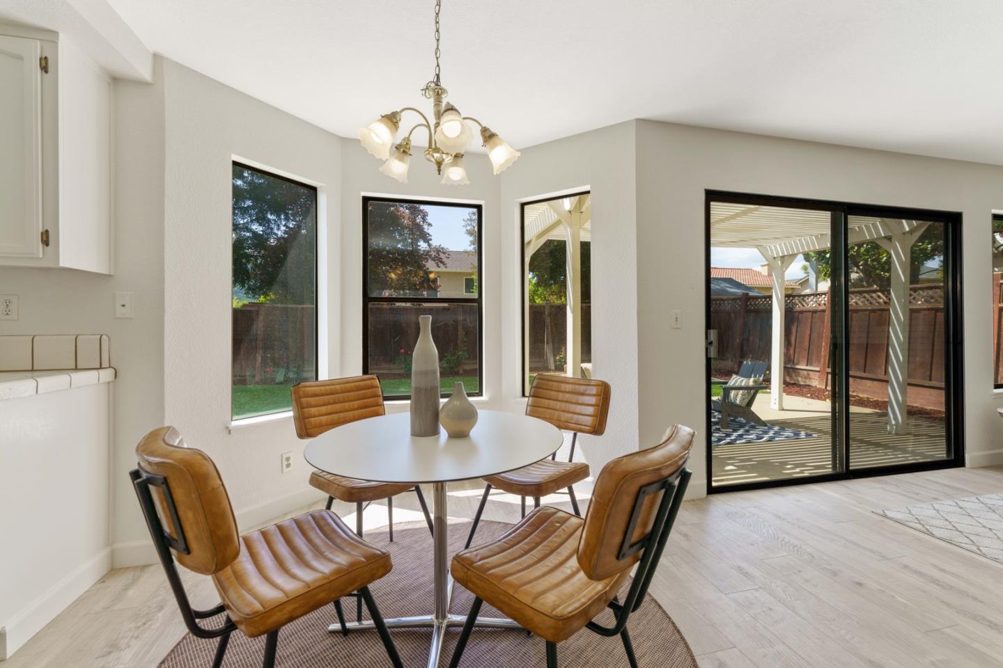 6702 Paseo Catalina Pleasanton, CA 94566 - Photo 15 of 44 a view of a dining room with furniture large windows and wooden floor